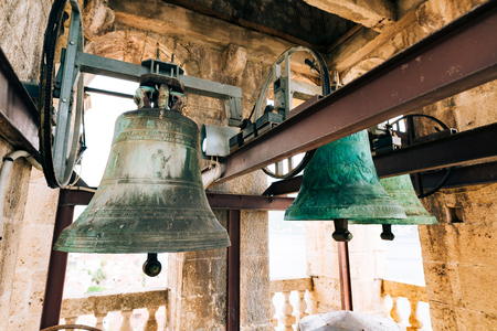 The bells in the chapel. Vintage old large bells in the bell tower near the church, in Croatia and Montenegro.の写真素材