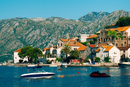 The old town of Perast on the shore of Kotor Bay, Montenegro. The ancient architecture of the Adriatic and the Balkans. Boats and yachts on the dock.の写真素材