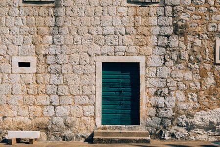 Green doors. Wood texture. Old shabby, irradiated paint. Old wooden doorsの写真素材