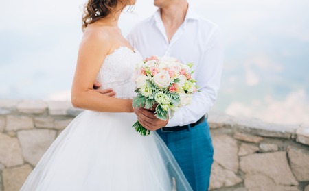 Wedding bridal bouquet of Lisianthus and Cineraria silver in the hands of the bride. Wedding in Montenegro.の写真素材