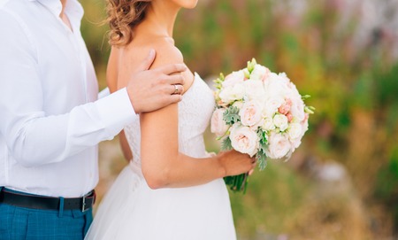 Wedding bridal bouquet of Lisianthus and Cineraria silver in the hands of the bride. Wedding in Montenegro.の写真素材