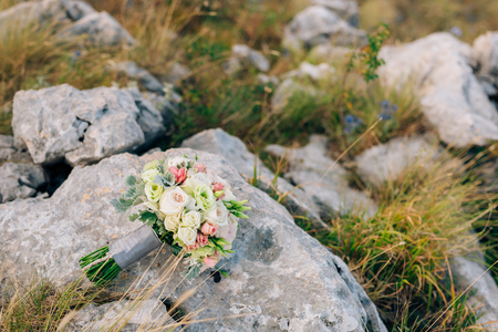 Wedding bridal bouquet of Lisianthus and Cineraria silver on the rocks. Wedding in Montenegro, Adriatic.の写真素材