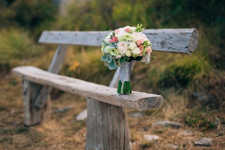 Wedding bridal bouquet of Lisianthus and Cineraria Silver on an old wooden bench handmade. Wedding in Montenegro, Adriatic.の写真素材