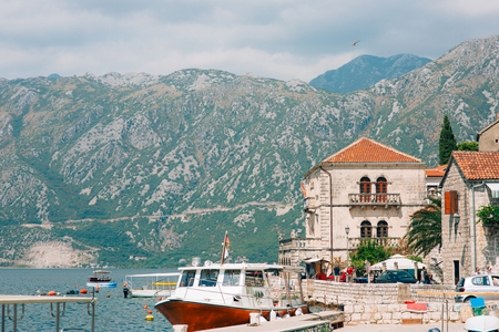 The old town of Perast on the shore of Kotor Bay, Montenegro. The ancient architecture of the Adriatic and the Balkans. Boats and yachts on the dock.の写真素材
