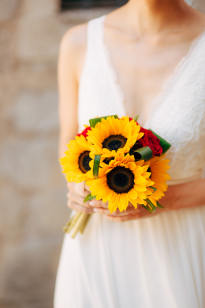 Wedding bridal bouquet of sunflowers in the hands of the bride. Wedding in Montenegro, Perast.の写真素材