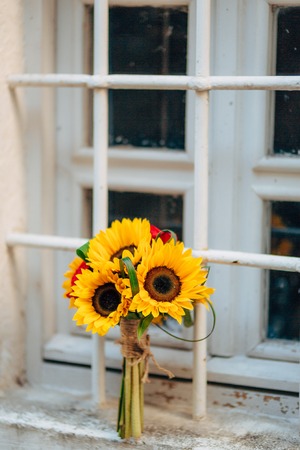 Wedding bridal bouquet of sunflowers on the window. Wedding in Montenegro, Perast.の写真素材