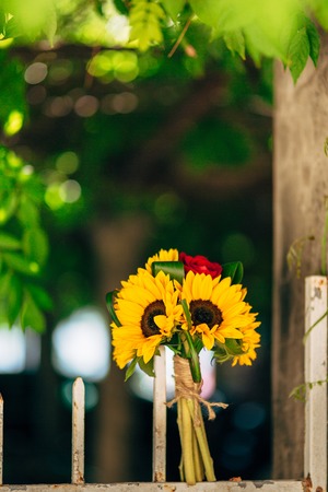 Wedding bridal bouquet of sunflowers on a metal fence. Wedding in Montenegro, Perast.の写真素材
