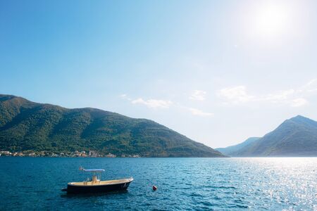 The old town of Perast on the shore of Kotor Bay, Montenegro. The ancient architecture of the Adriatic and the Balkans. Boats and yachts on the dock.の写真素材