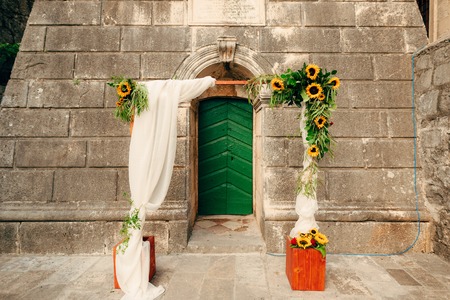 Wedding Arch of sunflowers. The ceremony at the St. Nikola Church in Perast, Montenegroの写真素材