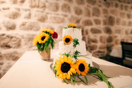 Wedding cake decorated with flowers of sunflower.の写真素材