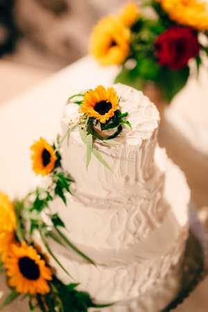 Wedding cake decorated with flowers of sunflower.の写真素材