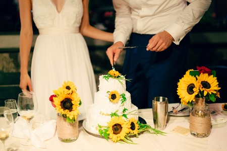 Wedding cake decorated with flowers of sunflower.の写真素材