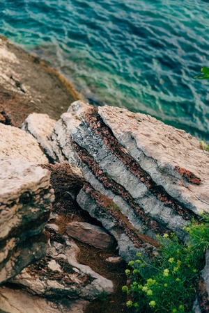 Rocks on the sea in Montenegro. Rocky coast. Wild beach. Dangerous coast.