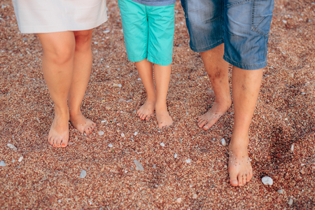 Family legs on the beach. Parents with children on the beach. Family holidays in Montenegro.の写真素材