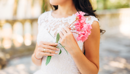 Oleander flower in the girls hands. Wedding in Montenegroの写真素材