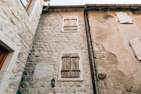 White window shutters. The facade of houses in Montenegro.の写真素材
