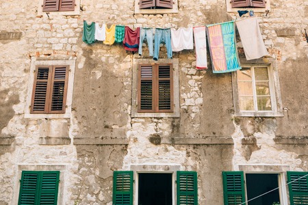 Green window shutters. The facade of houses in Montenegro.の写真素材