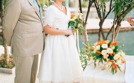 Bride and groom on the grass under the arch at the wedding ceremony in Montenegro.の写真素材