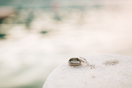 Wedding rings on the rocks near the sea. Wedding jewelry.の写真素材