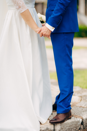 Bride and groom holding hands. Wedding in Montenegro.の写真素材