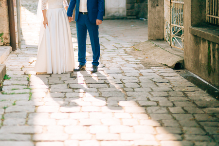 The shadow of the couple on the floor. Silhouette of the shadow of the newlyweds on the asphalt in Montenegro.の写真素材