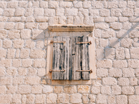 White window shutters. The facade of houses in Montenegro.の写真素材