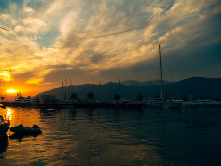 Yacht in the sea at sunset. Silhouette of a yacht on the background of the setting sun on the horizonの写真素材