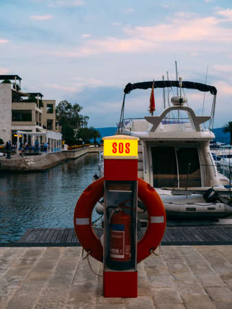Lifebuoy in the marina for yachts. Red circle on the boat dock. Porto Montenegro, Montenegro.の写真素材