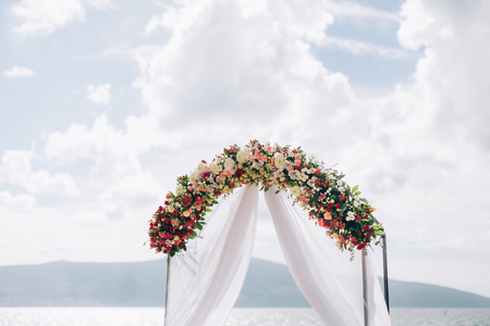 Wedding Arch on the beach in Montenegro. Panoramic views of the mountains and the Bay of Kotorの写真素材