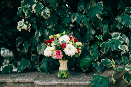 Wedding bridal bouquet of roses, chrysanthemums, Eucalyptus Baby Blue on the rocks. Wedding in Montenegro, Adriatic.の写真素材