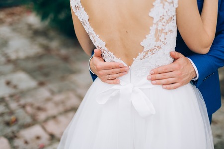 The groom embraces the bride in the old town. Wedding in Montenegro and Croatia.の写真素材