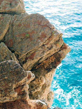 Rocks on the sea in Montenegro. Rocky coast. Wild beach. Dangerous coast.