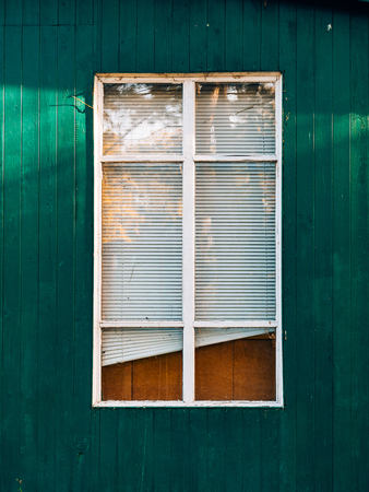 White window shutters. The facade of houses in Montenegro.
