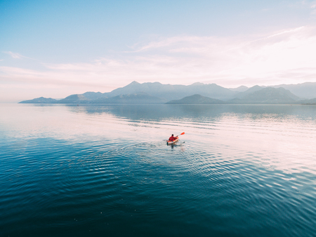 Kayaks in the lake. Tourists kayaking on the Bay of Kotor, near the town of Perast in Montenegro. Aerial Photo drone.の写真素材
