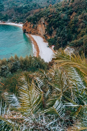 Snow on the beach. Snow-covered beach of the sea. Anomaly in Montenegro. A rare event. Snow on the beach in Budva, the Adriatic.の写真素材