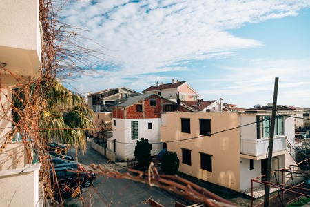 Unfinished two-storey house in Budva, Montenegro. Blue sky with clouds over houses.の写真素材