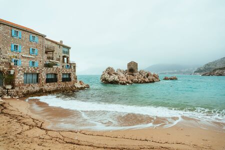 Przno, Montenegro. Beach, sun beds and umbrellas on the beach, the beach line.の写真素材