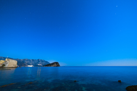 The island of St. Nicholas near Budva, Montenegro. Rocky shore, long exposure. Night photo with a starry sky.の写真素材