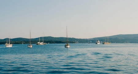 Moored boats in the Bay of Kotor, on the background of the peninsula Lustica in Montenegro. Away from the coastの写真素材