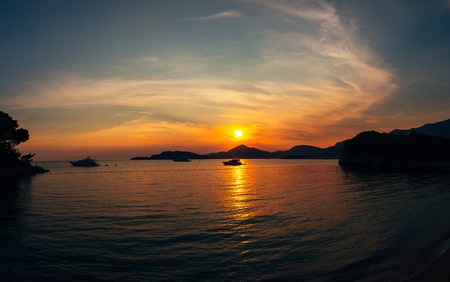 Sunset in Montenegro over the mountains and the sea. Orange sunsets.の写真素材