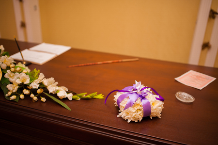 Wedding rings of a newly-married couple on a cushion for rings. Engagement gold rings. Wedding in Montenegro.の写真素材