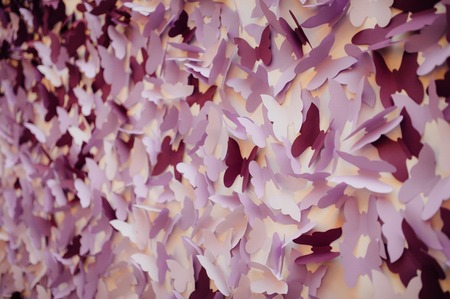 garland of paper butterflies. Textured background of paper.