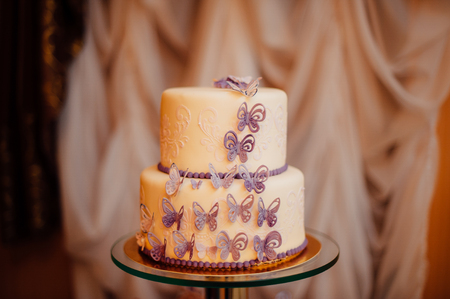 White wedding cake with flowers and blueberriesの写真素材