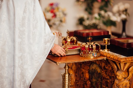 Two gold crowns close-up in a church.の写真素材