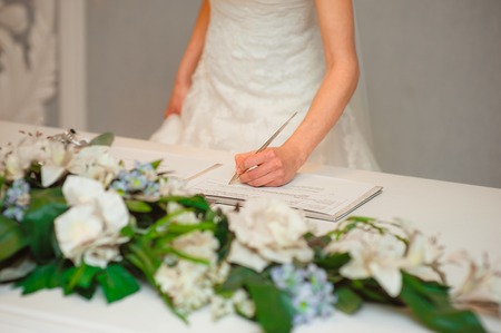 Newlyweds put their signatures in the act of registering a marriage at a wedding ceremony in Montenegro.の写真素材