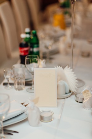 Blank bright yellow place card on wood table with hearts and ribbonの写真素材