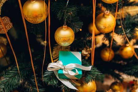 New years gift under the Christmas tree, decorated with balloonsの写真素材