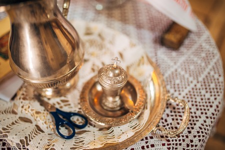 A set for baptizing a child on a table in a church.の写真素材