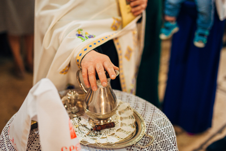 A set for baptizing a child on a table in a church.の写真素材