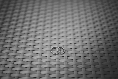 Gold wedding rings on a wooden backgroundの写真素材
